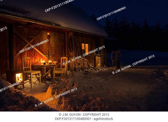 Cozy wooden cottage in dark winter forest snow countryside