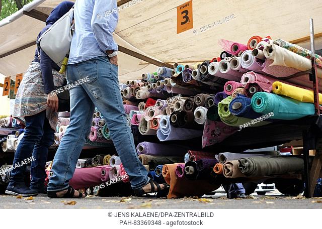 A trader offering different fabrics at the fabric market at Maybachufer in Neukoelln, Berlin, Germany, 20 Augsut 2016. The market takes place every Saturday...