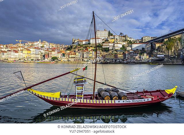 Ferreira Port wine boat called Rabelo Boat on a Douro River in Vila Nova de Gaia city. Porto city river bank on background