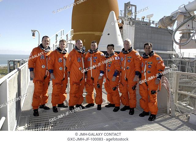 CAPE CANAVERAL, Fla. - After practicing emergency egress from the pad, the STS-119 crew members pose on the 225-foot level for a crew photo