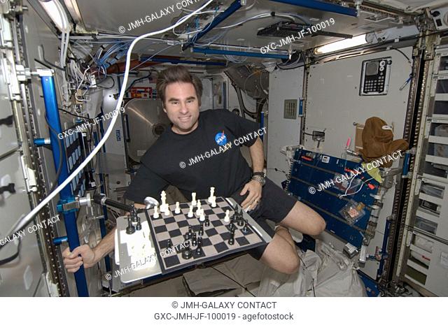 NASA astronaut Greg Chamitoff, Expedition 17 flight engineer, smiles for a photo near a chess board in the Harmony node of the International Space Station