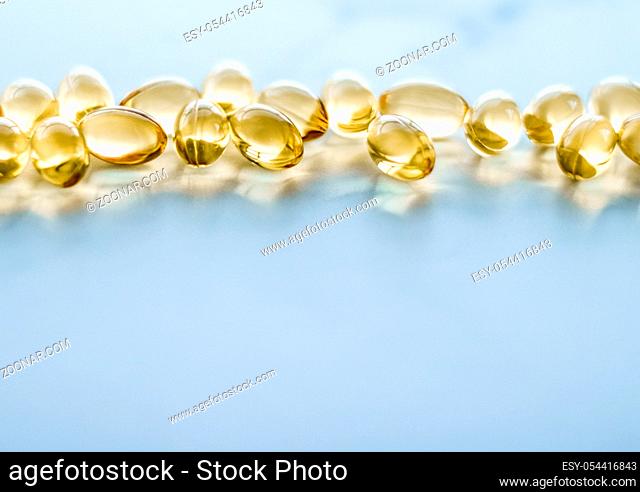 Pharmaceutical, branding and science concept - Vitamin D and golden Omega 3 pills for healthy diet nutrition, fish oil food supplement pill capsules