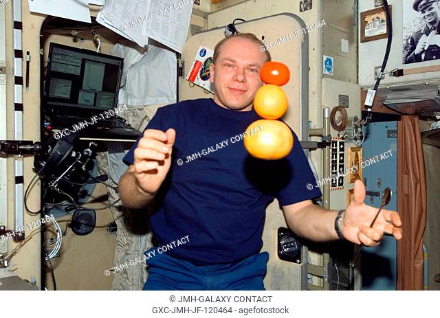 Cosmonaut Oleg V. Kotov, Expedition 15 flight engineer representing Russia's Federal Space Agency, is pictured near fresh fruit floating freely in the Zvezda...