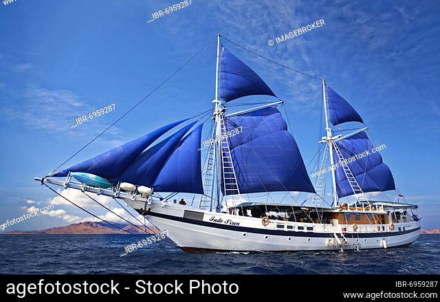 Sailing schooner S/Y Indo Siren, dive boat, liveaboard, under sail, seagoing ship, sails, blue, Flores Sea, Komodo National Park, Lesser Sunda Islands