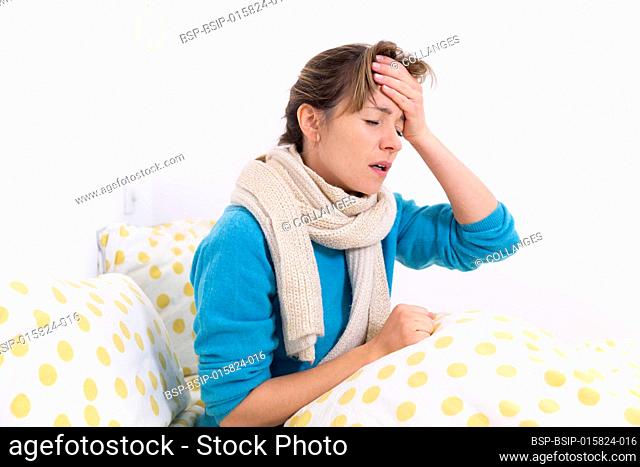 A young woman wrapped up in bed suffering from a flu-like condition with a migraine