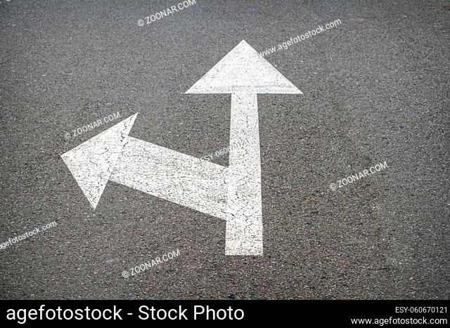 white arrows on asphalt road - street arrow
