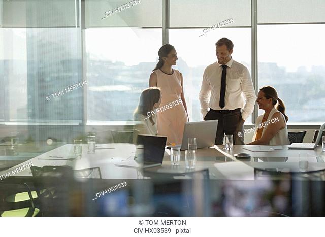 Business people talking at laptop in conference room meeting