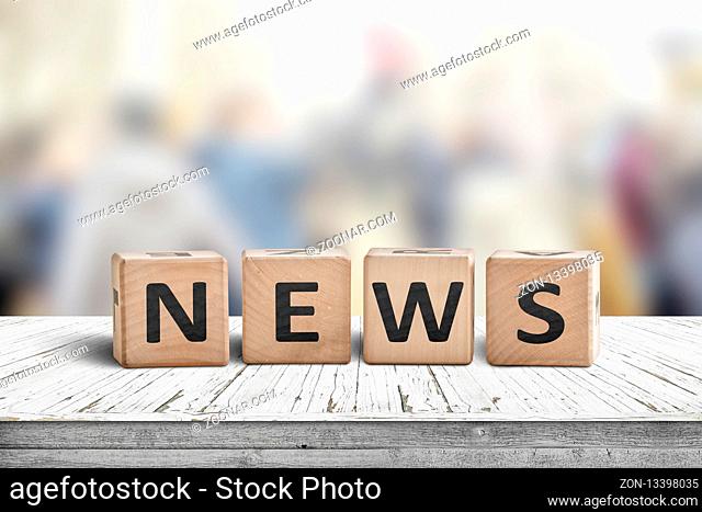 News sign on a worn wooden table with a blurry background in bright colors