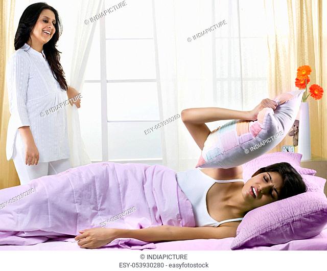 Mother waking her daughter up in the morning