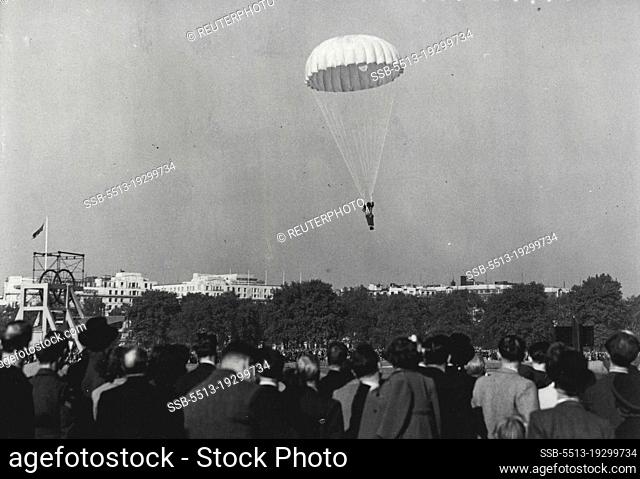 A Jump For Savings -- Watched by a large crowd, one of the paratroopers makes a descent into Hyde Park this afternoon, during the ""Silver Lining"" *****