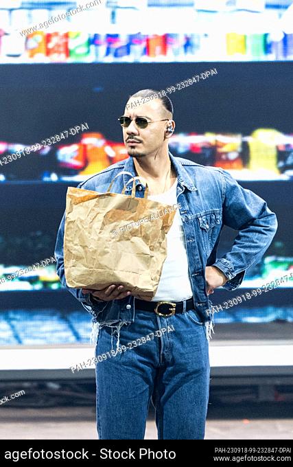 PRODUCTION - 17 September 2023, Berlin: German rapper and singer Apache 207 holds a paper bag during his performance at the Waldbühne. Photo: Hannes P