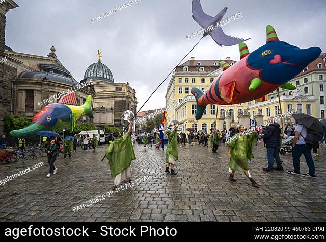 20 August 2022, Saxony, Dresden: The theater group V.O.S.A. from Prague parades through Dresden's city center with its colorful figures and various devices...