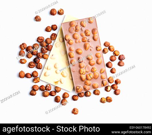 White and dark chocolate bars with hazelnuts isolated on white background
