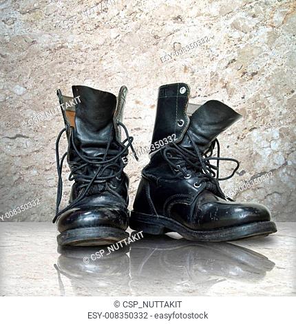 old black boot on white marble