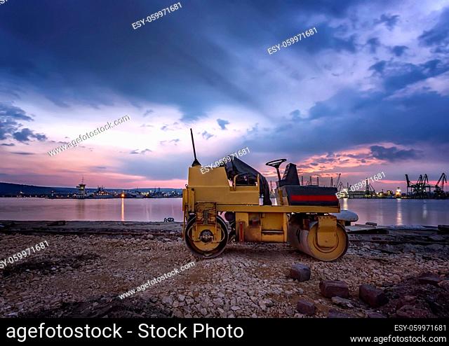 Amazing view at small roller at a construction site in a beautiful twilight