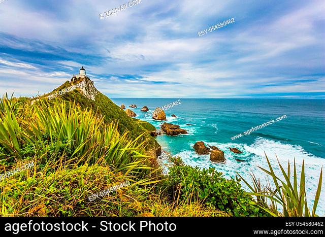 Nugget Point Lighthouse on the cape of the Kathlins coast of the South Island. Travel to New Zealand. The concept of active, eco and photo tourism