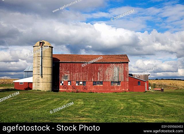 Colorful Midwest scene - red barn under cloudy sky
