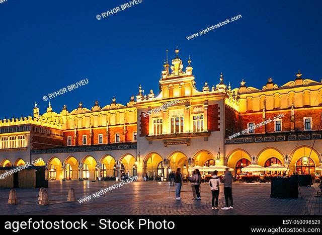 Krakow, Poland. Evening Night View Of Cloth Hall Building Of The Main Market Square. Famous Historical Landmark And UNESCO World Heritage Site
