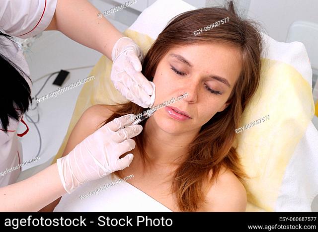 Mesotherapy. Beautiful woman gets an injection in her face