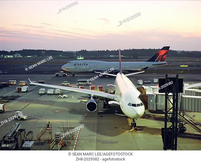 Airplanes parked at The Narita International Airport at dusk