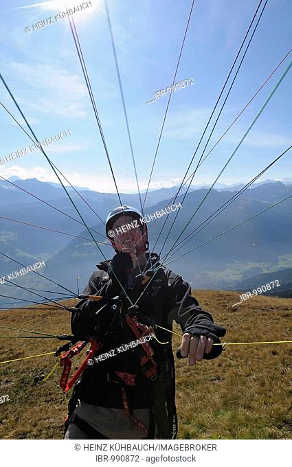 Paraglider preparing for takeoff, holding the lines, testing the wing in flight, Monte Cavallo, Sterzing, Province of Bolzano-Bozen, Italy, Europe