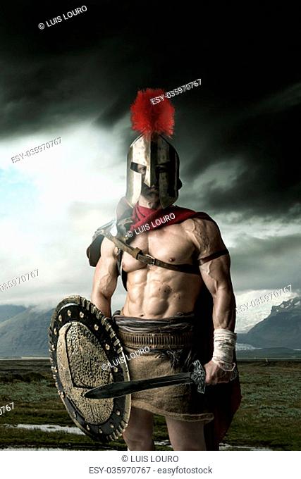 Ancient warrior or Gladiator posing outdoors with helmet