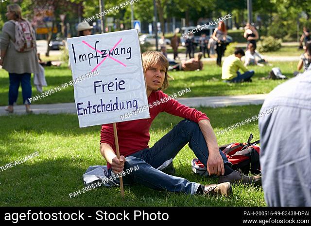16 May 2020, Rhineland-Palatinate, Koblenz: During an unauthorized demonstration against the Corona restrictions, a man shows a sign in front of the...