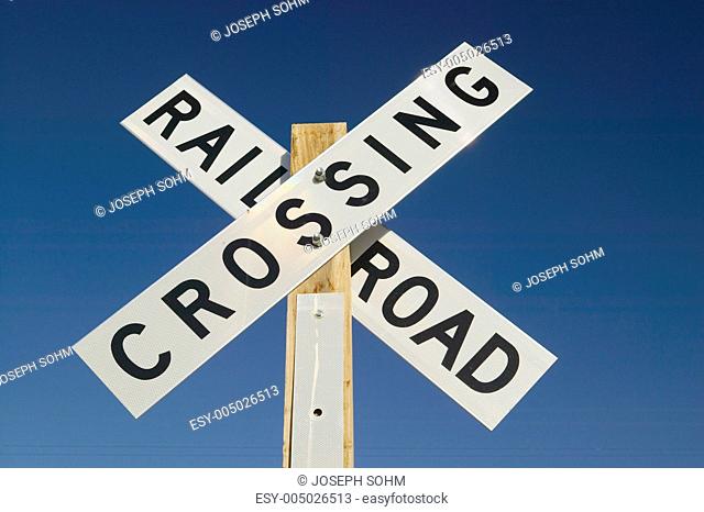 Railroad crossing sign and intersection in Mojave Desert of Southern California