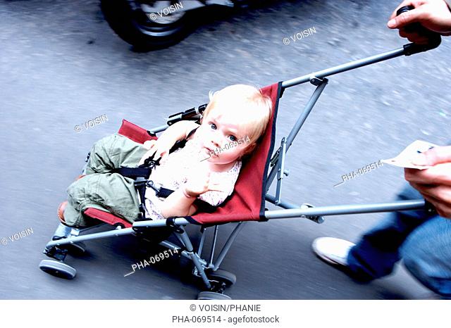 18 months old baby girl in a baby stroller