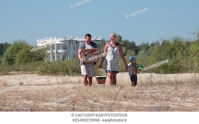 Happy family going on pinic to the beach