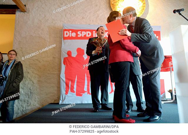 SPD Chancellor Candidate Peer Steinbrueck kisses Ulla Baumgarten, who was honored for 25 years of SPD membership, during the New Year's reception in local...