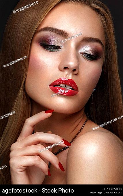 Beautiful girl with classic colorful make up and red lips.. Beauty face. Photos shot in studio