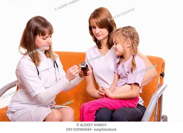 Pediatrician is going to give a sick child sitting on hands at mother medicine from spoon