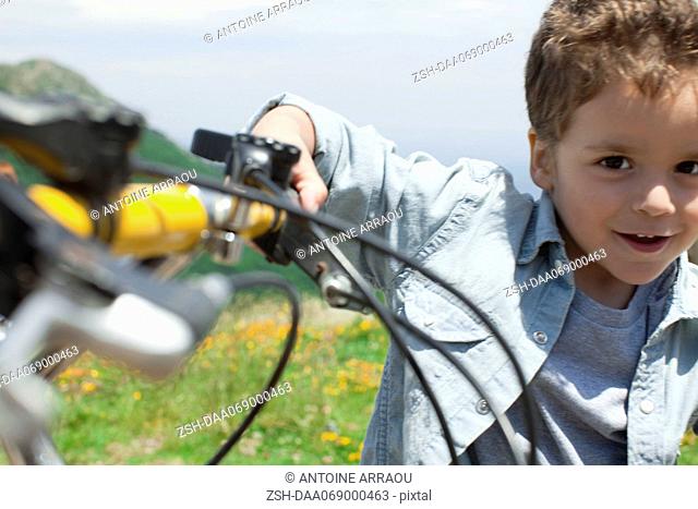 Boy riding bicycle, portrait