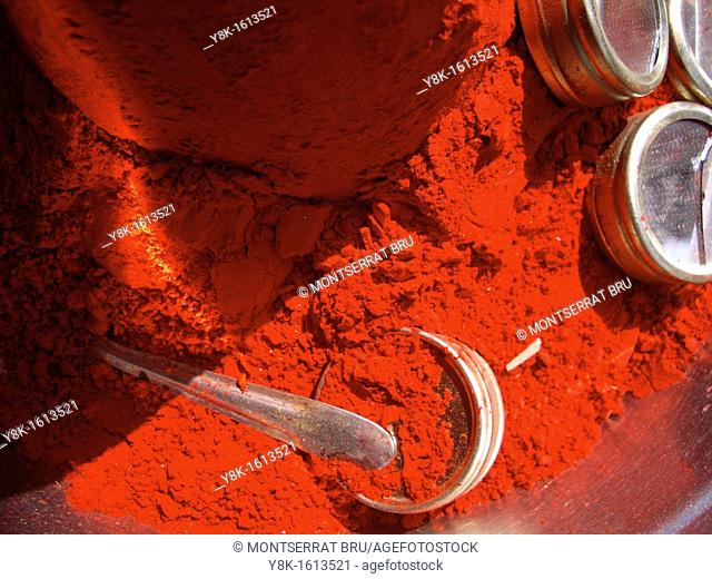 Red pigment pile with silver mirror boxes and silver spoon in Rishikesh, Uttarkhand, India