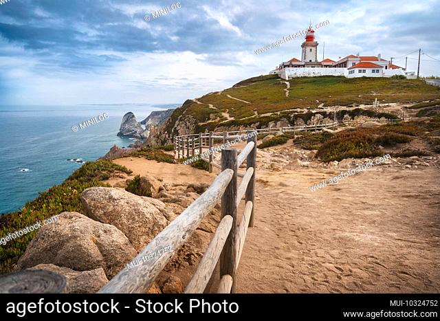 Sintra Portugal. Cape Roca and red lighthouse. Cabo da Roca. Travel and tourism landmark with beautiful coastline cliffs of atlantic ocean