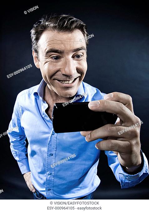 caucasian man toothy smile holding cellphone portrait isolated studio on black background