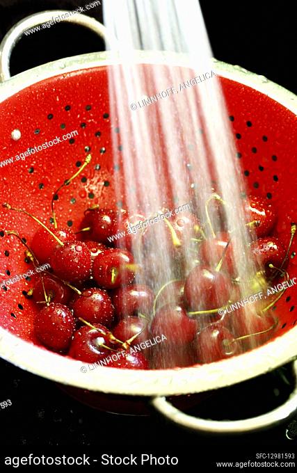 Cherries being washed in a colander