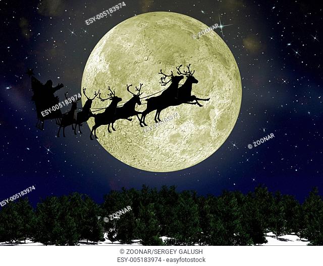 Santa Claus On Sledge With Deer against the bright moon