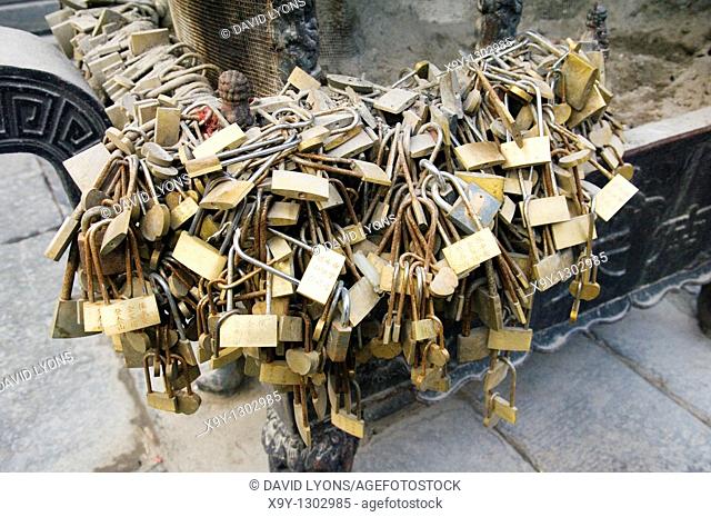 Tai Shan holy mountain, Shandong, China  Couples seeking good fortune leave padlocks on incense stand at the South Heavenly Gate