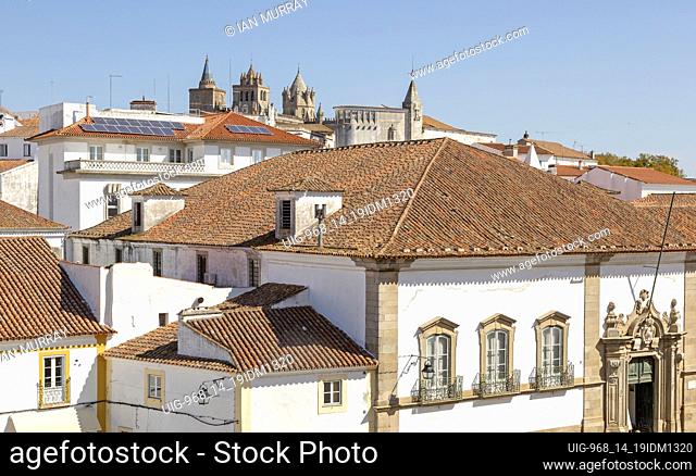 Panoramic style cityscape views over pan tile rooftops and whitewashed buildings in the city centre of Evora, Alto Alentejo, Portugal, southern Europe