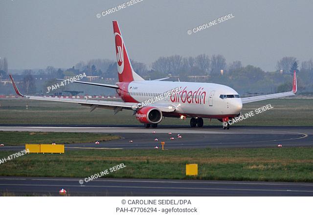 An aircraft of the German airline Air Berlin has landed at the airport in Duesseldorf, Germany, 30 March 2014. Photo: Caroline Seidel/dpa | usage worldwide