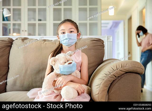 child and mother in medical masks while coronavirus quarantined at home