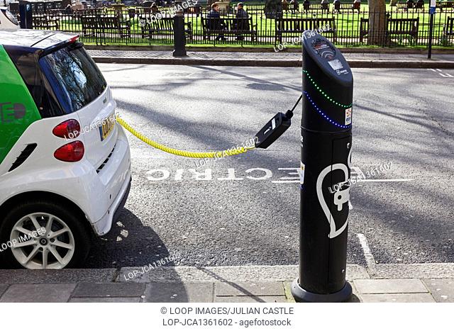 An electric car at a charging point in Berkeley Square in London