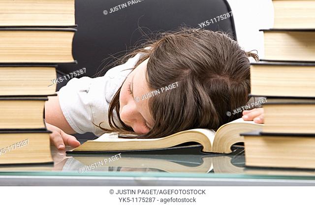 Shot of a Young School Child Asleep at her Desk
