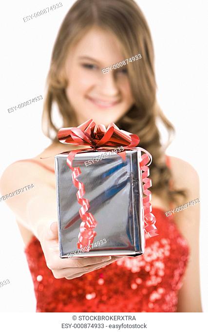 Close-up of Christmas present in females hand being given by smart girl