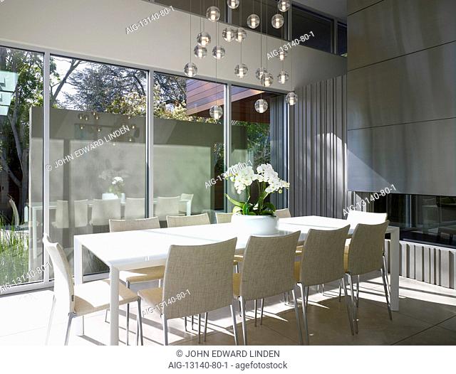 Dining table with light display at glass windows of Menlo Park Residence, California, USA