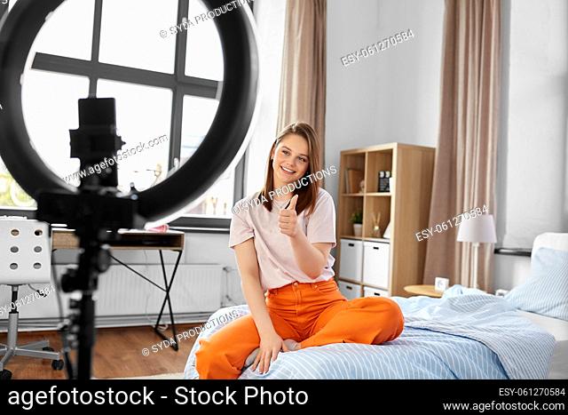 girl blogger with ring light showing thumbs up