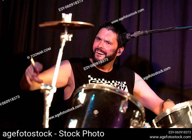 Male Musician Playing Drums And Cymbals At Concert