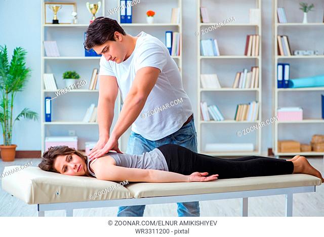 Young doctor chiropractor massaging female patient woman